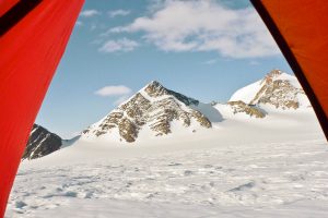 View from my tent. Pyramid Peaks are visible through open door of tent, in field camp on Larson Glacier